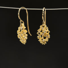 A pair of textured, lacy leaf-shaped earrings on ear wires with 7 tiny diamonds per leaf