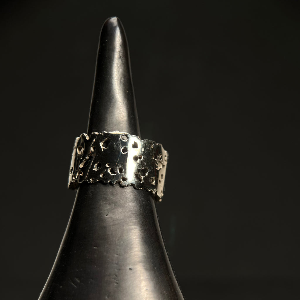 Flat band with organic holes and edges; shown in high polish with 11 widths, 14k white gold