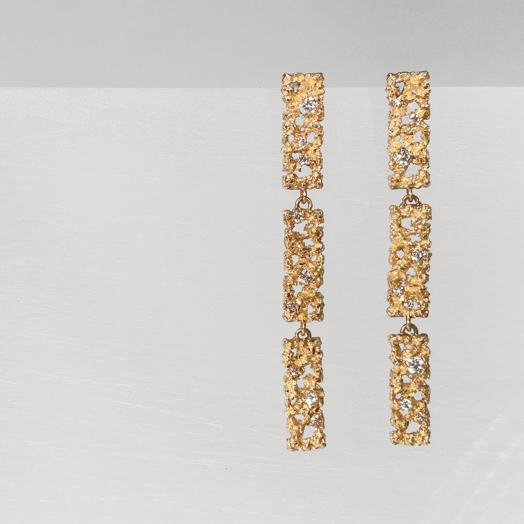 Post earring; three vertical rectangles with texture and negative space and diamonds, connected with jump rings