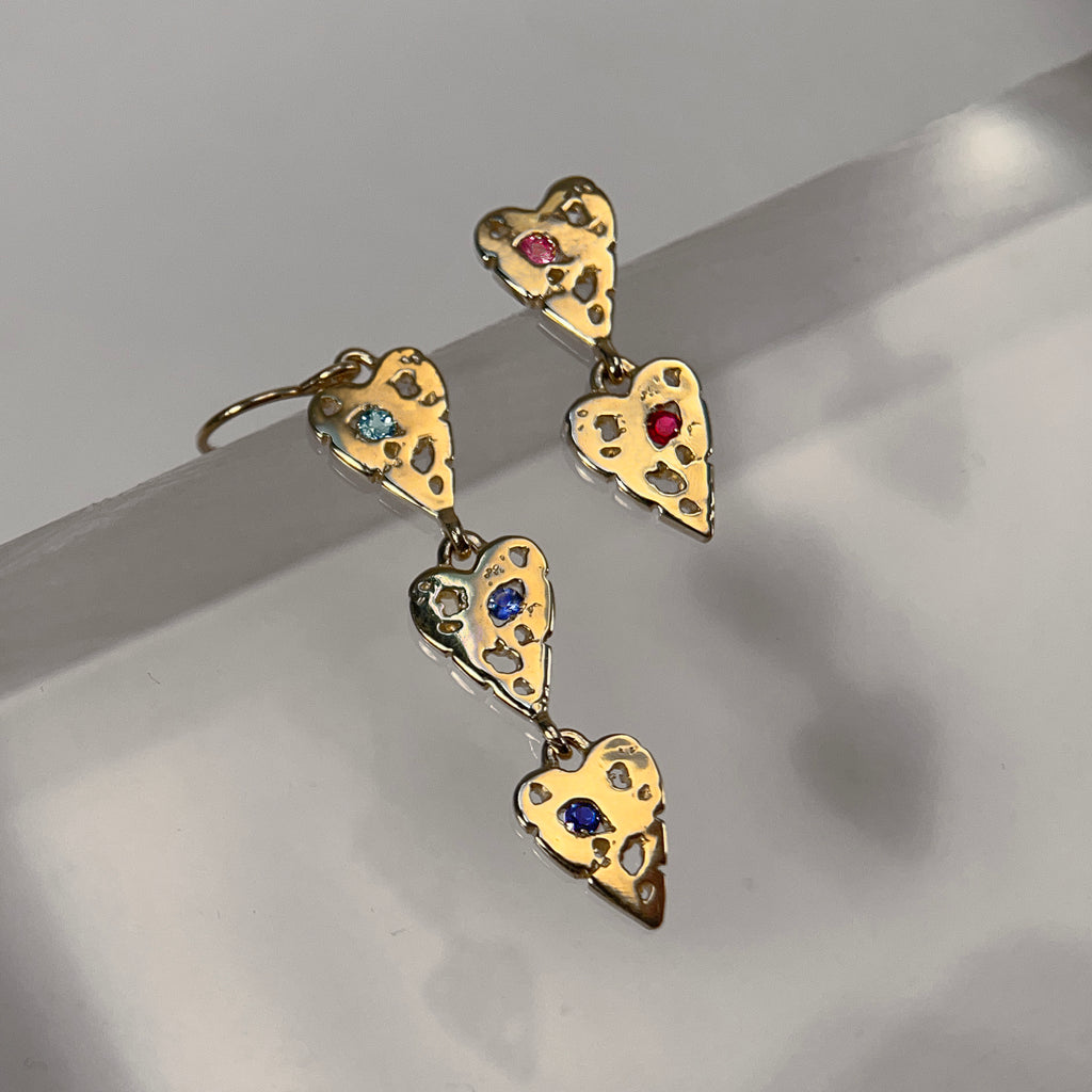 polished heart earrings with negative space; shown with 3 in a row and blue stones, and also with 2 in a row and pink stones