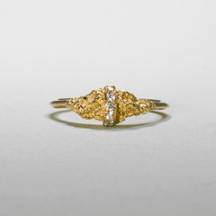 A ring with a textured moutain, bissected by a diamond strip; remainder of band in thin and polished