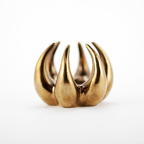 6 sculpted talons curve outward and upward and toward center where they can support taper candle; polished cast bronze