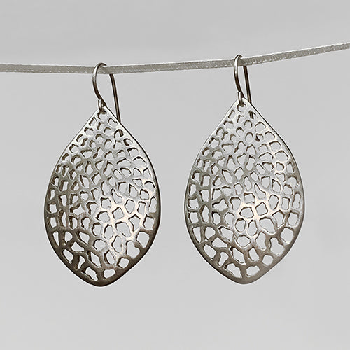 leaf-shaped, slightly convex earring on wire; has overall pattern made by organic cutouts; shown in silver