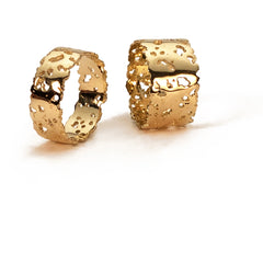 Flat bands with organic holes and edges; shown in high polish; two sizes shown, 7 and 11 widths