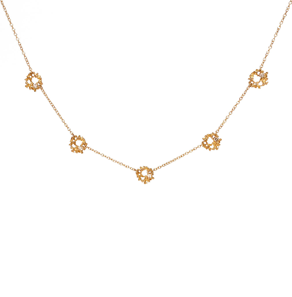 Lacy, textured, tiny piece; 5 of these are strung along chain; each has a white diamond set off-center