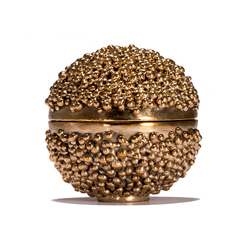Small spherical footed box; tiny drops cover most of the top and bottom halves; a band of polished metal runs horizontally around the center where the box opens 