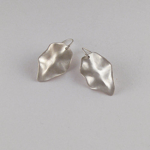 Very sculptural leaf-shaped earring on wire; edges are large, rolling, hills; mimics dried leaf